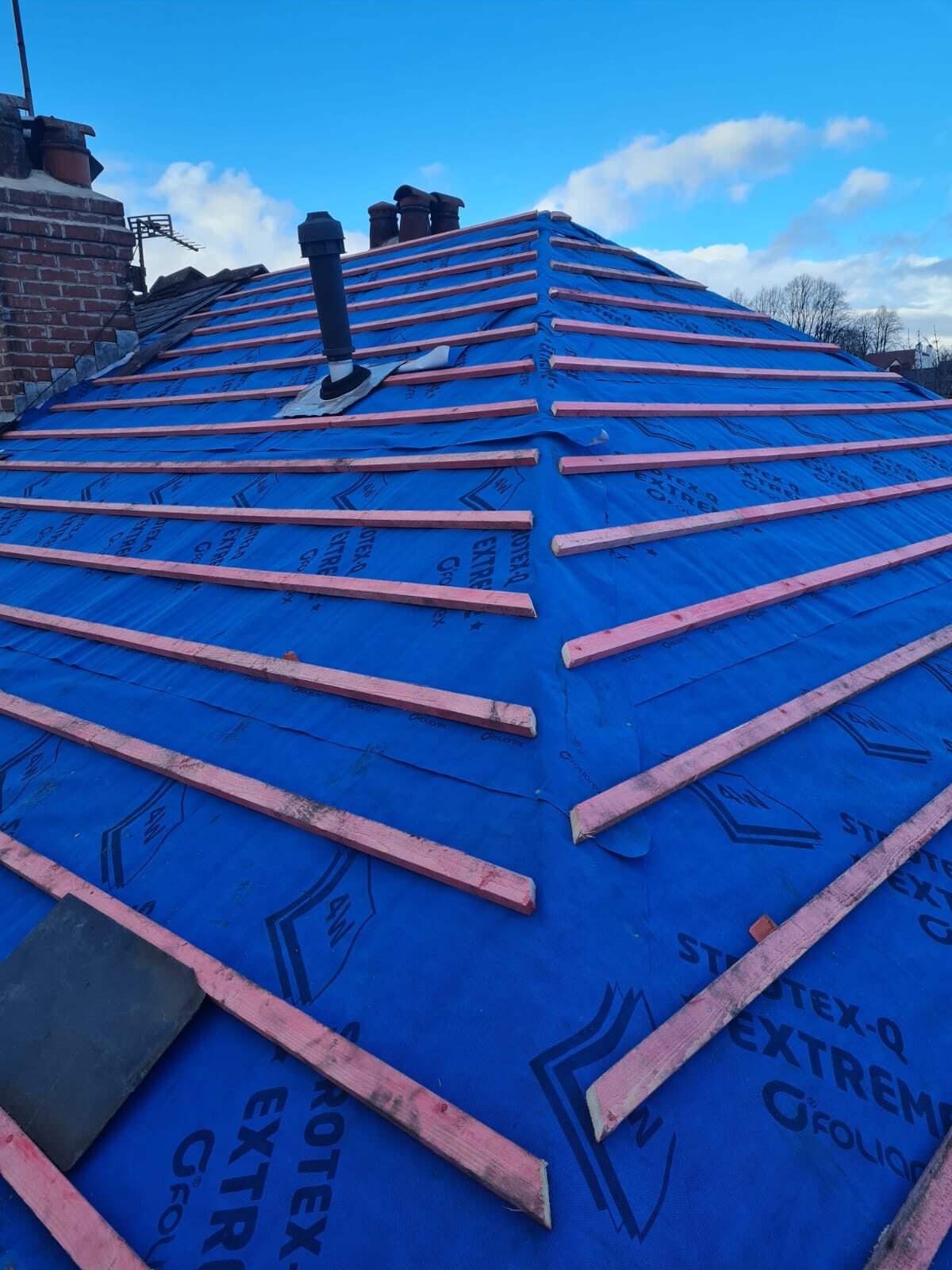 Roof stripped to membrane and battens ready for re-tile