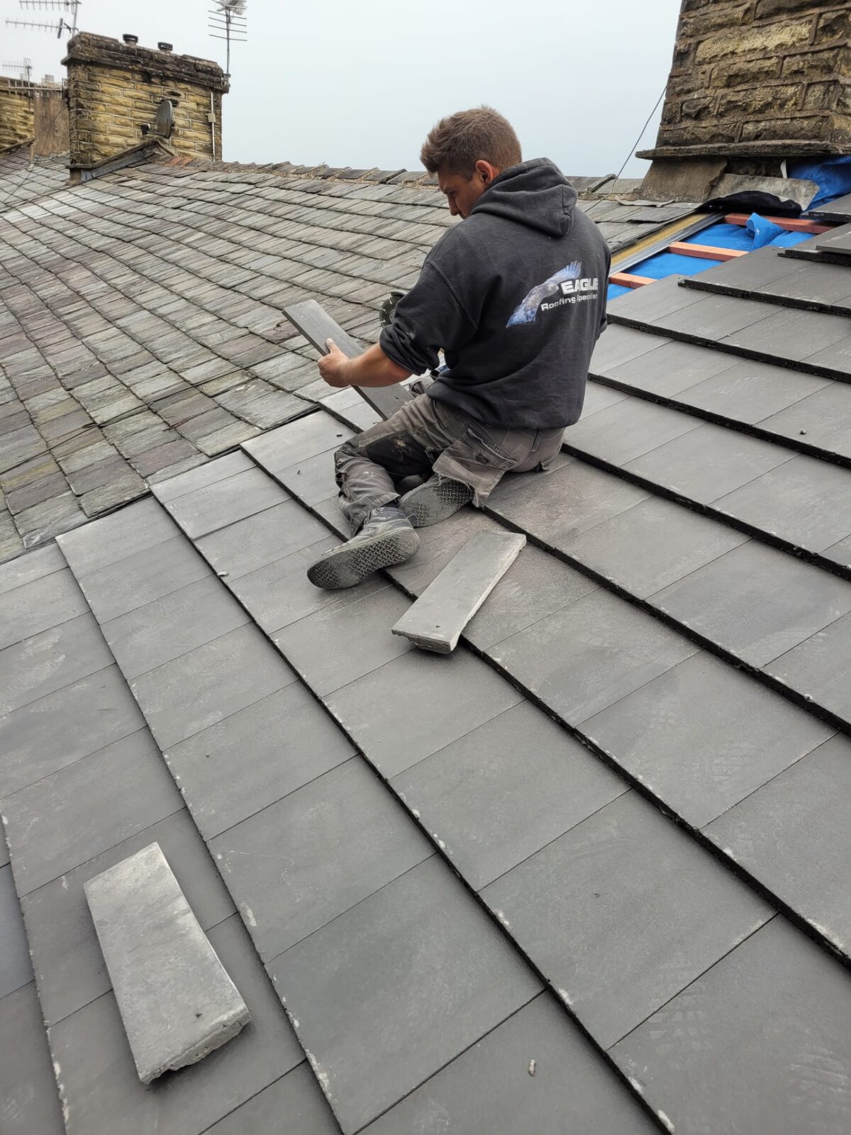 Eagle Roofing specialist laying new slates on a roof